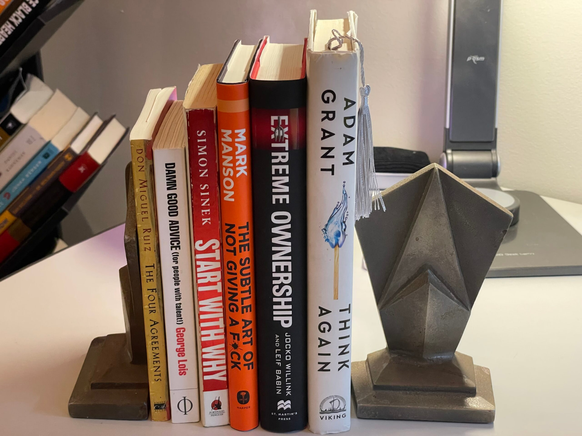 Adam's recommended books on his desk between geometric bookends